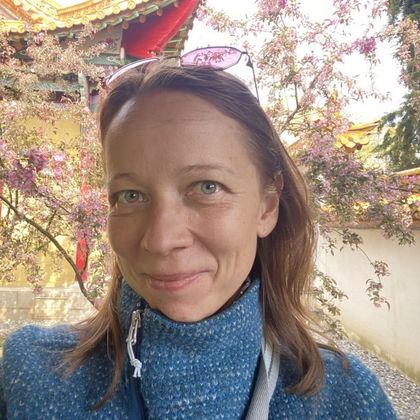 Irina Varlamova by a tree in blossom in spring